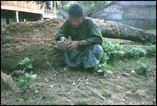 47-year-old Saw N--- [photo C-3], a local resident of Bpoh Loh Hta, holds a DKBA-deployed landmine which KNLA soldiers retrieved from Kuh Thuh Hta village tract, Papun District and subsequently defused.